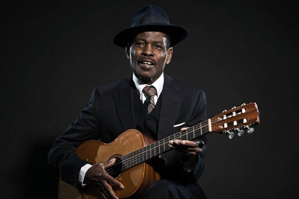 Person playing blues on acoustic guitar